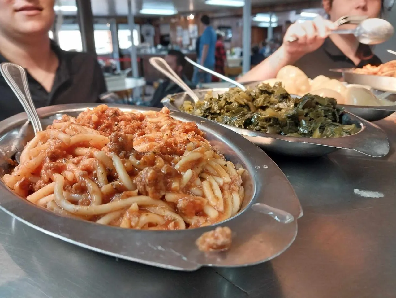 Scratch spaghetti and collard greens on a lazy-Susan table at Bea's