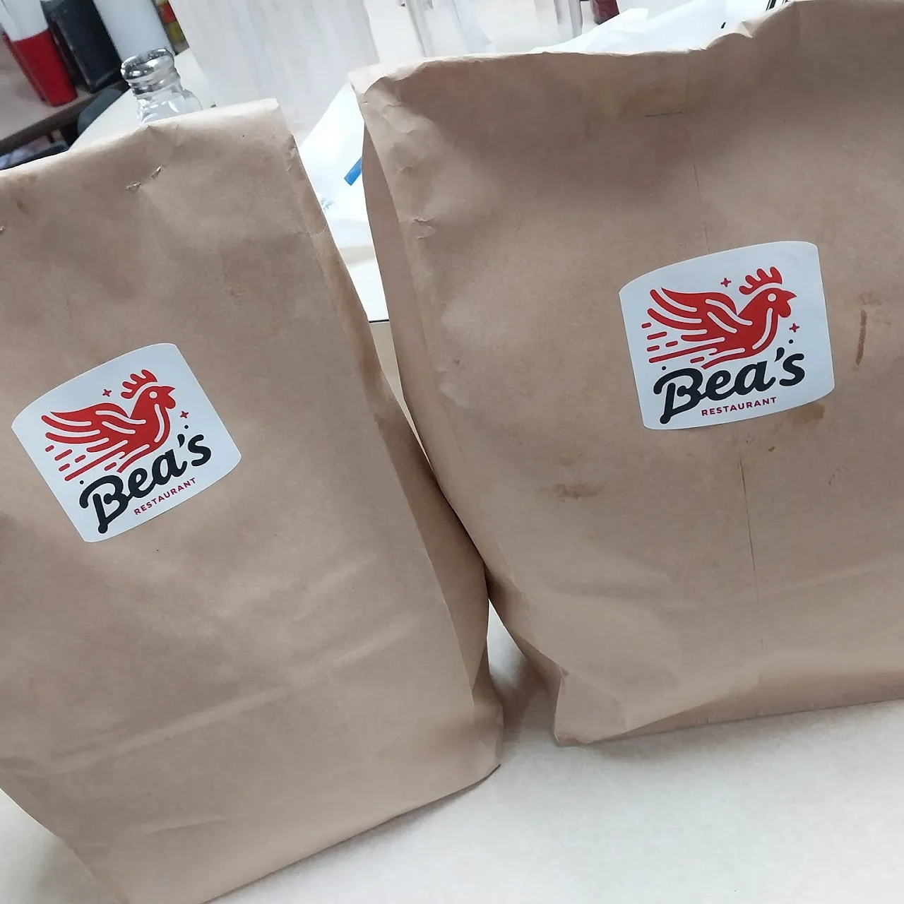 Bea's rooster-stamped takeout bags packed and ready to go